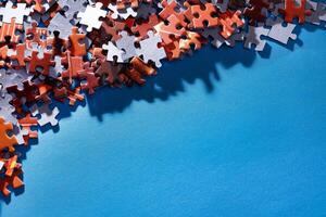 Mixed Pieces of a Colorful Jigsaw Puzzle Lie on the Blue Background With Copy Space - Strategy and Solving Problem Concept photo