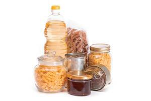 Food Reserves. Canned Food, Spaghetti, Pate, Tuna, Tomato Juice, Pasta, Fish and Grocery - Isolated on White Background. Emergency Food Storage in Case of Crisis. Strategic Food Supplies - Isolation photo
