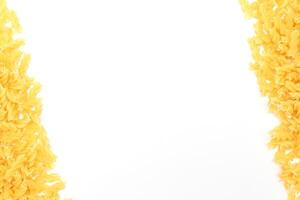 Uncooked Fusilli Pasta with Copy Space on White Background. Raw and Dry Macaroni. Fat and Unhealthy Food - Flat Lay photo