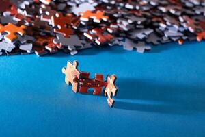 Mixed Pieces of a Colorful Jigsaw Puzzle Lie on the Blue Background - Strategy and Solving Problem Concept photo