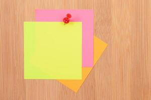 Colored Sticky Notes with Copyspace Pinned to the Wooden Message Board. To Do List Reminder in Office. Blank Memo Sticker at Work - Template. Empty Checklist - Mockup photo
