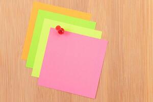 Colored Sticky Notes with Copyspace Pinned to the Wooden Message Board. To Do List Reminder in Office. Blank Memo Sticker at Work - Template. Empty Checklist - Mockup photo