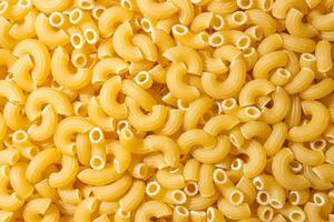 Uncooked Chifferi Rigati Pasta. A Culinary Canvas of Chifferi Rigati, Creating a Lively and Textured Background for Gourmet Cooking. Dry Pasta. Raw Macaroni - Top View, Flat Lay photo