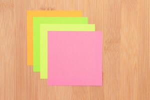 Colored Sticky Notes with Copyspace Pinned to the Wooden Message Board. To Do List Reminder in Office. Blank Memo Sticker at Work - Template. Empty Checklist - Mockup photo