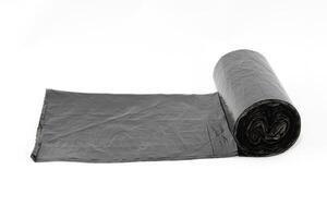 Black Polyethylene Garbage Bags on White Background - Close-Up. The Roll of Plastic Junk Package photo