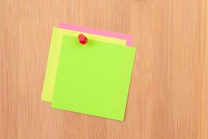 Colored Sticky Notes with Copyspace Pinned to the Wooden Message Board. To Do List Reminder in Office. Blank Memo Sticker at Work - Template. Empty Checklist - Mockup photo