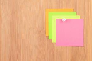 Colored Sticky Notes with Copyspace Pinned to the Wooden Message Board. To Do List Reminder in Office. Blank Memo Sticker at Work - Template. Empty Checklist - Mockup photo