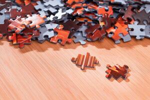 Colorful Pieces of a Mixed Jigsaw Puzzle Lie on the Wooden Table - Strategy and Solving Problem Concept photo