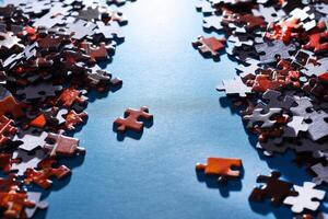 Mixed Pieces of a Colorful Jigsaw Puzzle Lie on the Blue Background - Strategy and Solving Problem Concept photo