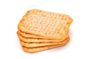 Stack of Crispy Salted Crackers with Greens - Isolated on White. Easy Snack - Isolation photo