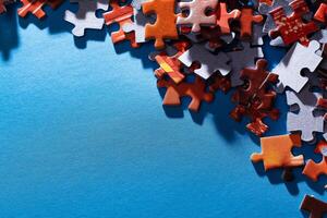 Mixed Pieces of a Colorful Jigsaw Puzzle Lie on the Blue Background With Copy Space - Strategy and Solving Problem Concept photo