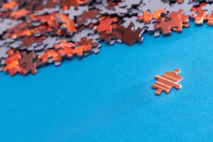 Mixed Pieces of a Colorful Jigsaw Puzzle Lie on the Blue Background - Strategy and Solving Problem Concept photo