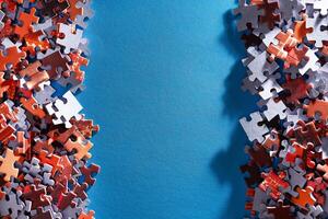 Mixed Pieces of a Colorful Jigsaw Puzzle Lie on the Blue Background With Copy Space - Strategy and Solving Problem Concept photo