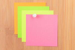 Colored Sticky Notes with Copyspace Pinned to the Wooden Message Board. To Do List Reminder in Office. Blank Memo Sticker at Work - Template. Empty Checklist - Mockup photo