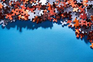 Mixed Pieces of a Colorful Jigsaw Puzzle Lie on the Blue Background With Copy Space - Strategy and Solving Problem Concept photo