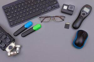 Top View of Blogger's Workplace. Digital Gadgets Lying on Grey Table - Flat Lay photo