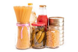 Food Reserves. Canned Food, Spaghetti, Pate, Tuna, Tomato Juice, Pasta, Fish and Grocery - Isolated on White Background. Emergency Food Storage in Case of Crisis. Strategic Food Supplies - Isolation photo