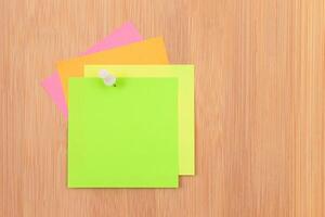 Colored Sticky Notes with Copyspace Pinned to the Wooden Message Board. To Do List Reminder in Office. Blank Memo Sticker at Work - Template. Empty Checklist - Mockup photo