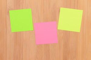 Colored Sticky Notes with Copyspace Pinned to the Wooden Message Board. To Do List Reminder in Office. Blank Memo Sticker at Work - Template. Empty Checklist - Mockup photo