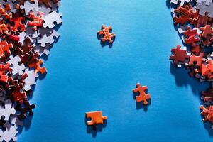 Mixed Pieces of a Colorful Jigsaw Puzzle Lie on the Blue Background - Strategy and Solving Problem Concept photo
