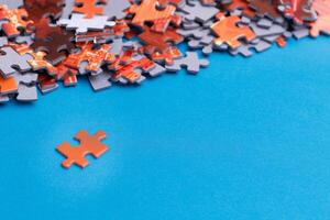 Mixed Pieces of a Colorful Jigsaw Puzzle Lie on the Blue Background With Copy Space - Strategy and Solving Problem Concept photo