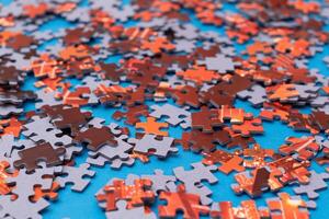 Mixed Pieces of a Colorful Jigsaw Puzzle Lie on the Blue Background - Strategy and Solving Problem Concept photo
