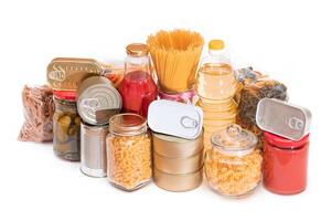 Food Reserves. Canned Food, Spaghetti, Tomato Juice, Pasta and Grocery - Isolated on White Background. Emergency Food Storage in Case of Crisis. Strategic Food Supplies - Isolation photo