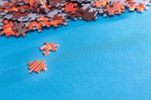 Mixed Pieces of a Colorful Jigsaw Puzzle Lie on the Blue Background - Strategy and Solving Problem Concept photo