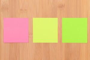 Colored Sticky Notes with Copyspace Pinned to the Wooden Message Board. To Do List Reminder in Office. Blank Memo Sticker at Work - Template. Empty Checklist - Mockup photo