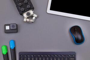 Top View of Blogger's Workplace. Digital Gadgets Lying on Grey Table - Flat Lay photo