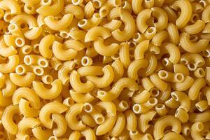 Uncooked Chifferi Rigati Pasta. A Culinary Canvas of Chifferi Rigati, Creating a Lively and Textured Background for Gourmet Cooking. Dry Pasta. Raw Macaroni - Top View, Flat Lay photo