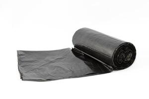 Black Polyethylene Garbage Bags on White Background - Close-Up. The Roll of Plastic Junk Package photo