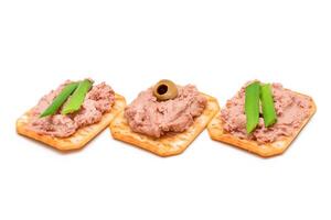 Crispy Salted Crackers with Liver Pate, Green Onions and Olives - Isolated on White. Easy Snack - Isolation photo