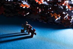 Mixed Pieces of a Colorful Jigsaw Puzzle Lie on the Blue Background - Strategy and Solving Problem Concept photo