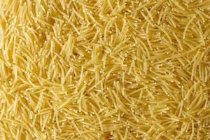 Uncooked Filini Pasta. A Culinary Canvas of Noodles, Creating a Lively and Textured Background for Gourmet Cooking. Dry Pasta. Raw Macaroni - Top View, Flat Lay photo