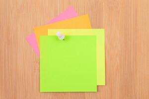 Colored Sticky Notes with Copyspace Pinned to the Wooden Message Board. To Do List Reminder in Office. Blank Memo Sticker at Work - Template. Empty Checklist - Mockup photo