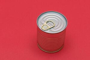 Unopened Tin Can with Blank Edge on Red Background. Canned Food. Aluminum Can for Safe and Long Term Storage of Food. Steel Sealed Food Storage Container photo
