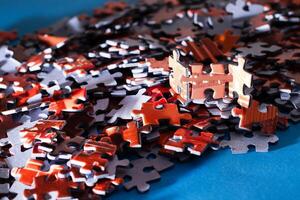Mixed Pieces of a Colorful Jigsaw Puzzle Lie on the Blue Background - Strategy and Solving Problem Concept photo