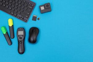 Top View of Photographer's, Videographer's or Blogger's Workplace. Digital Gadgets Lying on Blue Table - Flat Lay photo