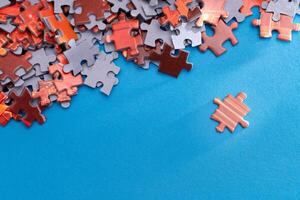 Mixed Pieces of a Colorful Jigsaw Puzzle Lie on the Blue Background - Strategy and Solving Problem Concept photo