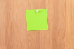 Green Sticky Note Pinned to the Wooden Message Board. To Do List Reminder in Office. Blank Memo Sticker at Work - Template. Empty Checklist - Mockup photo