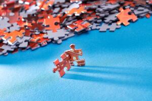 Mixed Pieces of a Colorful Jigsaw Puzzle Lie on the Blue Background - Strategy and Solving Problem Concept photo