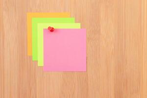 Colored Sticky Notes with Copyspace Pinned to the Wooden Message Board. To Do List Reminder in Office. Blank Memo Sticker at Work - Template. Empty Checklist - Mockup photo