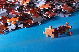Mixed Pieces of a Colorful Jigsaw Puzzle Lie on the Blue Background - Strategy and Solving Problem Concept photo