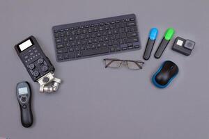 Top View of Blogger's Workplace. Digital Gadgets Lying on Grey Table - Flat Lay photo