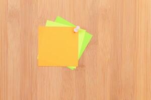 Colored Sticky Notes with Copyspace Pinned to the Wooden Message Board. To Do List Reminder in Office. Blank Memo Sticker at Work - Template. Empty Checklist - Mockup photo