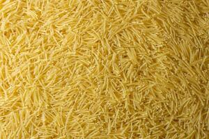Uncooked Filini Pasta. A Culinary Canvas of Noodles, Creating a Lively and Textured Background for Gourmet Cooking. Dry Pasta. Raw Macaroni - Top View, Flat Lay photo