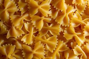 Uncooked Farfalle Pasta. A Culinary Canvas of Bow-Tie Macaroni, Creating a Lively and Textured Background for Gourmet Cooking. Dry Pasta. Raw Macaroni - Top View, Flat Lay photo