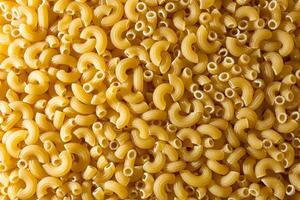 Uncooked Chifferi Rigati Pasta. A Culinary Canvas of Chifferi Rigati, Creating a Lively and Textured Background for Gourmet Cooking. Dry Pasta. Raw Macaroni - Top View, Flat Lay photo