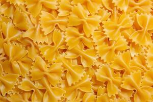Uncooked Farfalle Pasta. A Culinary Canvas of Bow-Tie Macaroni, Creating a Lively and Textured Background for Gourmet Cooking. Dry Pasta. Raw Macaroni - Top View, Flat Lay photo